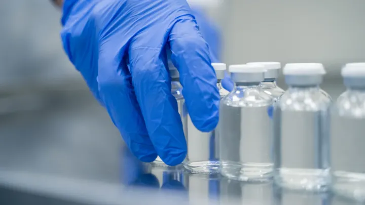 scientist hand working with vials
