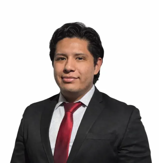 Smiling man with dark hair wearing a white shirt and dark blazer against a light background.