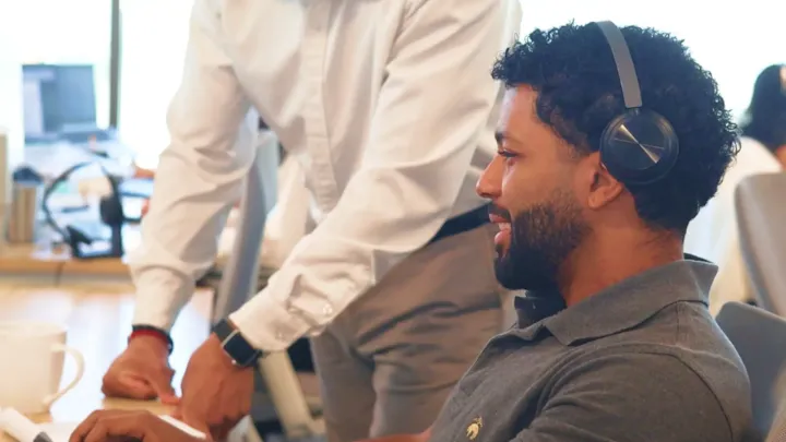 man with headphones smiling and talking