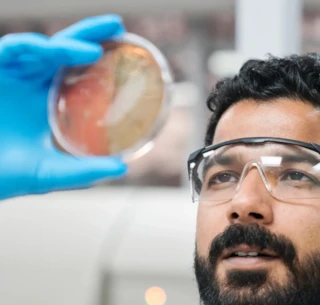 scientist in a lab inspecting item