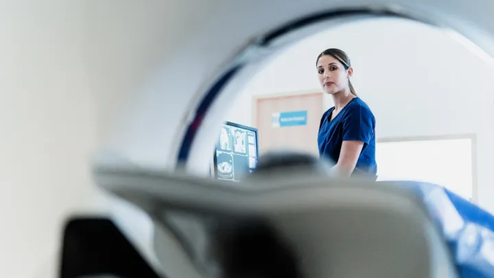 technician looking at patient during scan